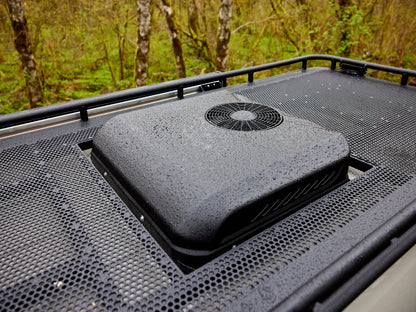 Roof-mounted air conditioning unit on a vehicle with a forest background