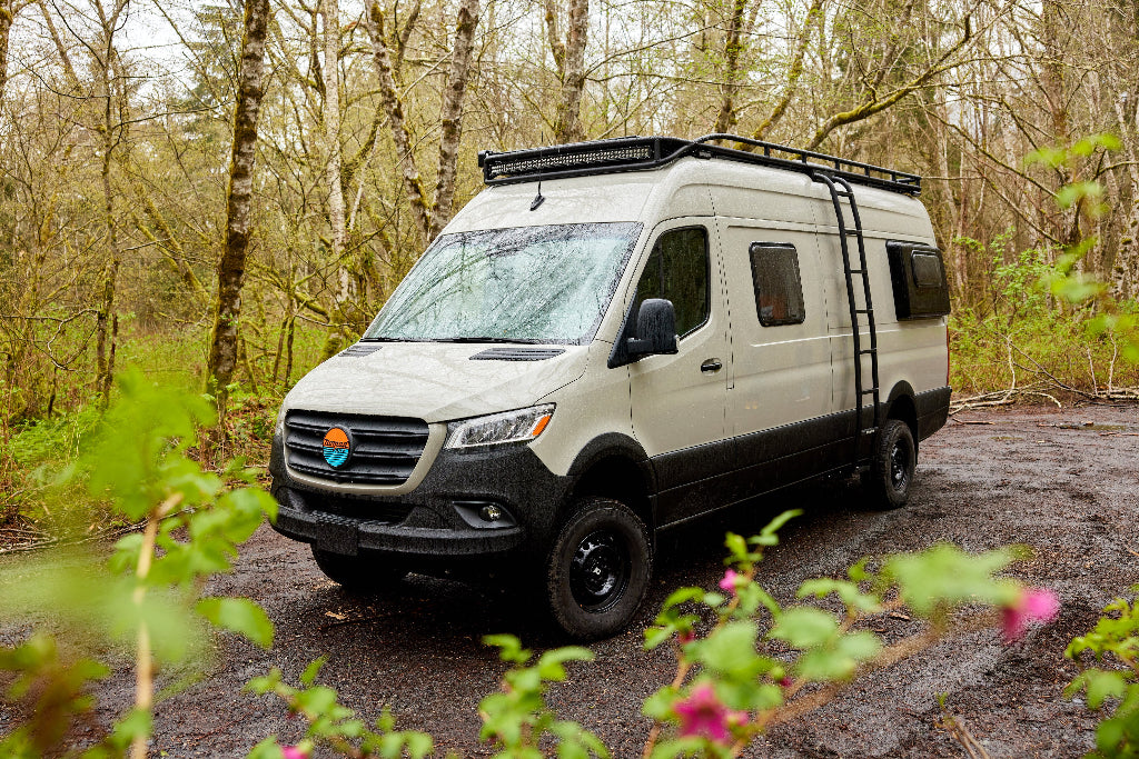 White van with roof rack on a forest road
