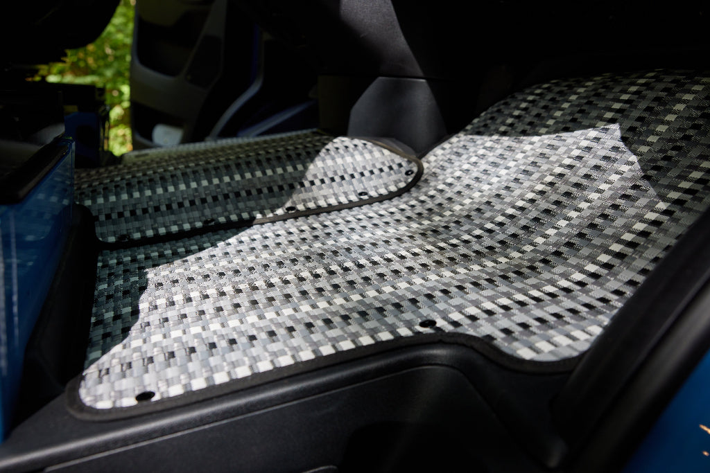 Automotive front mat with woven pattern on a mat