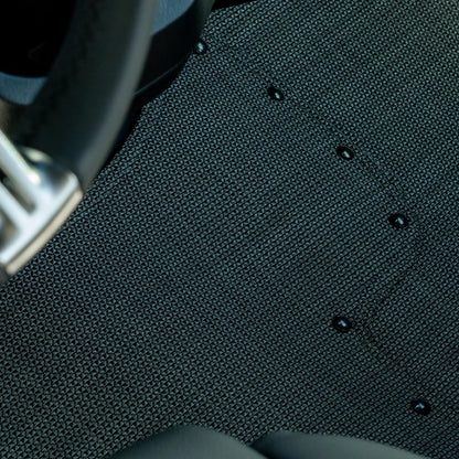 Nomad Vanz Matz in Meteor — tight detail of Chilewich Link surface and snap fasteners at Sprinter steering column
