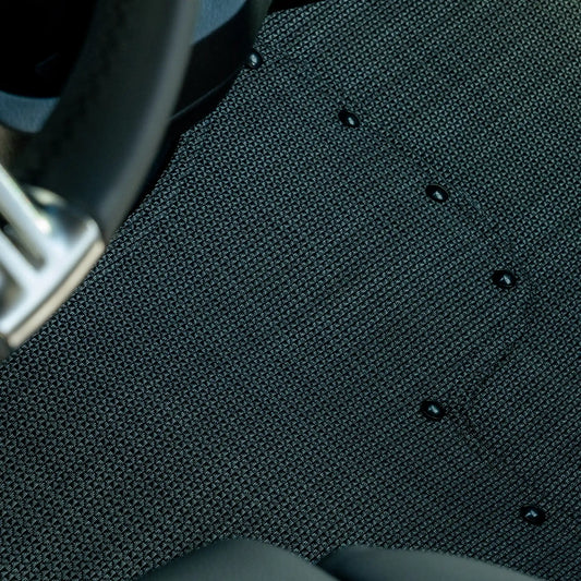Nomad Vanz Matz in Meteor — tight detail of Chilewich Link surface and snap fasteners at Sprinter steering column