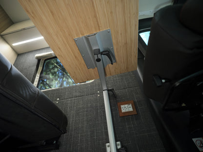 Close-up of a Lagun swivel table arm and adjustment lever mounted under a bamboo tabletop in a Nomad Vanz Sprinter