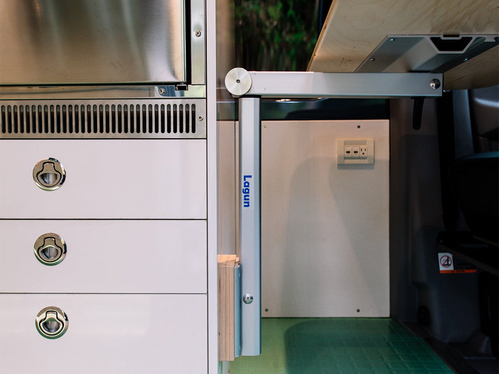 Lagun table leg system installed in camper van interior, silver anodized aluminum arm and wall-mounted bracket