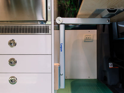Lagun table leg system installed in camper van interior, silver anodized aluminum arm and wall-mounted bracket